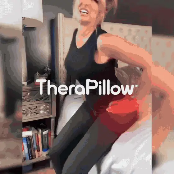 TheraPillow being secured between the knees to support the upper leg